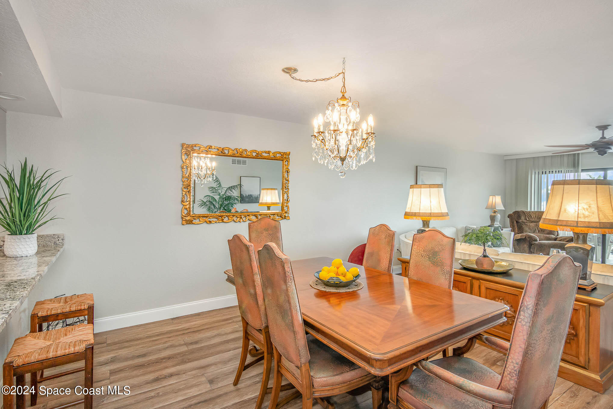 300 South Banana River Boulevard, Unit 305 Cocoa Beach, FL 32931 - Photo 17 of 36 a view of a dining room with furniture and chandelier