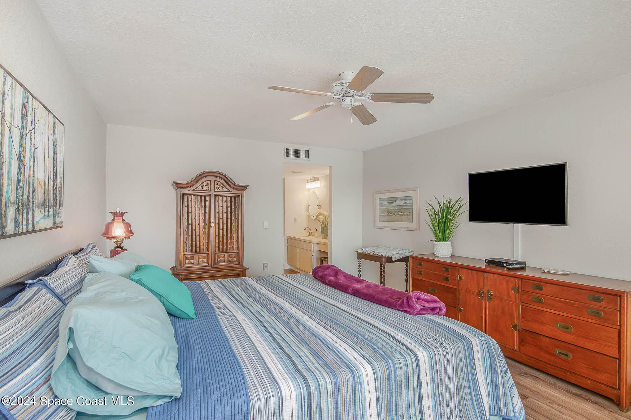 300 South Banana River Boulevard, Unit 305 Cocoa Beach, FL 32931 - Photo 26 of 36 a bedroom with a bed and a flat screen tv
