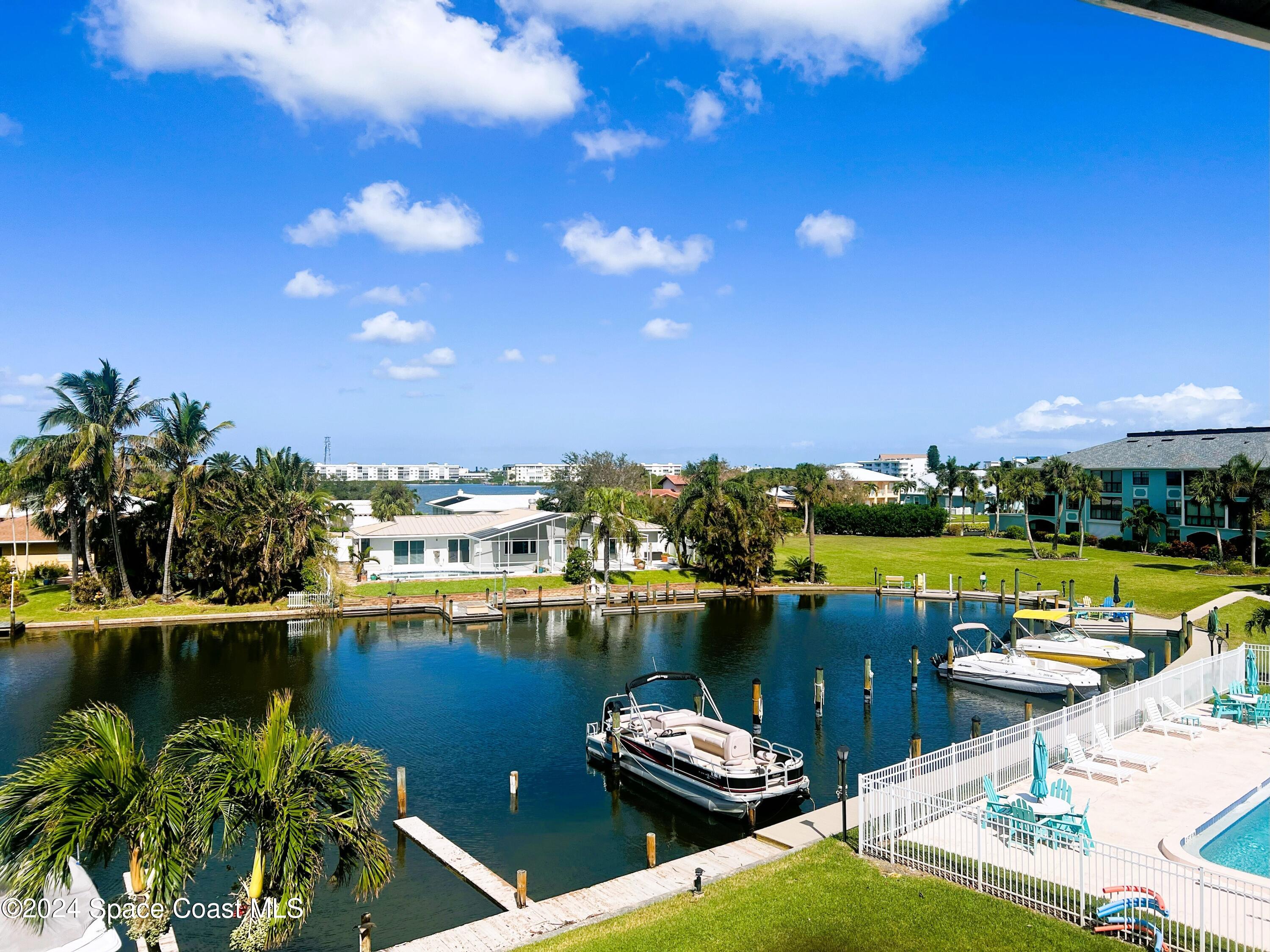 300 South Banana River Boulevard, Unit 305 Cocoa Beach, FL 32931 - Photo 30 of 36 a view of a lake with lawn chairs
