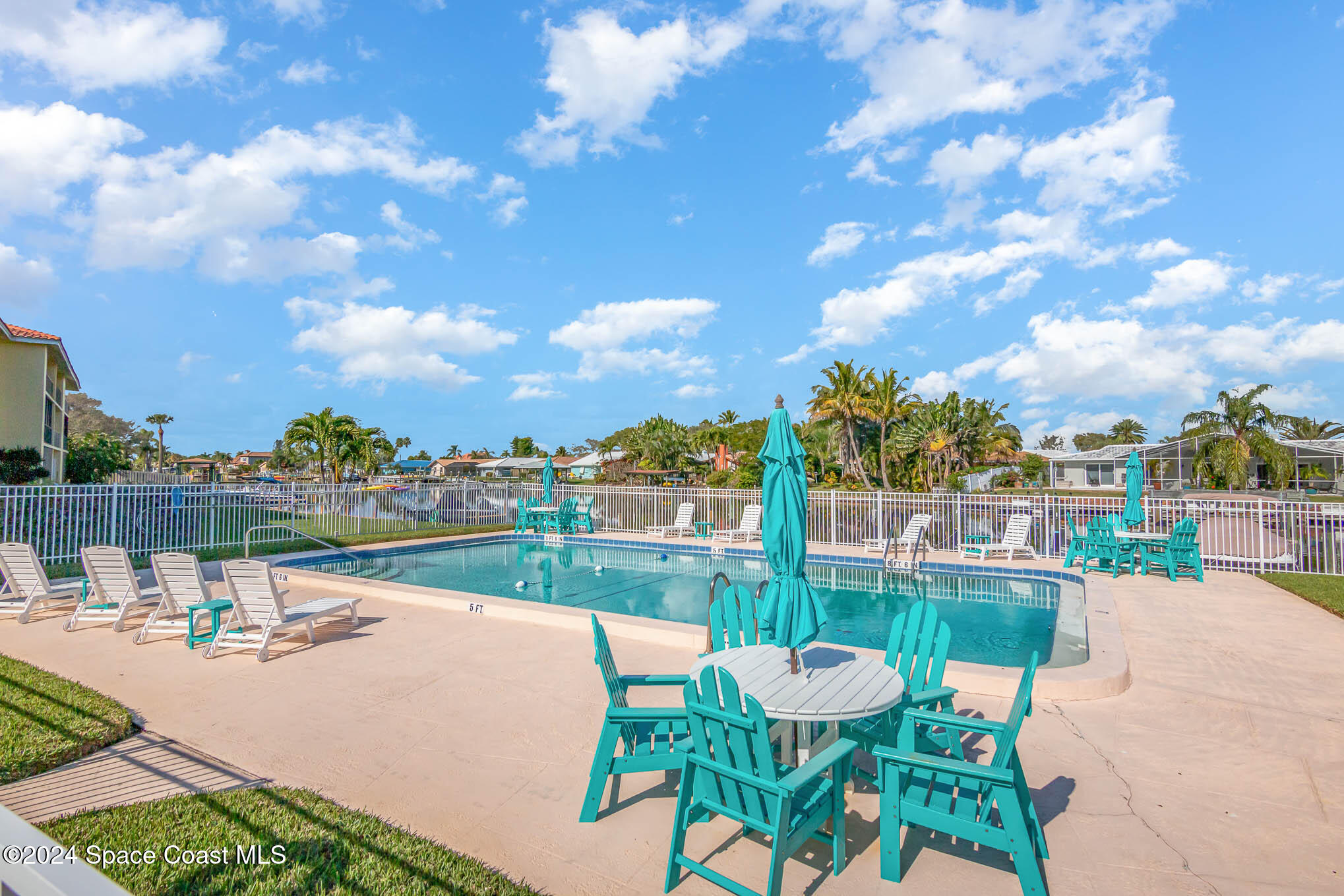 300 South Banana River Boulevard, Unit 305 Cocoa Beach, FL 32931 - Photo 4 of 36 a view of a lake with a table and chairs