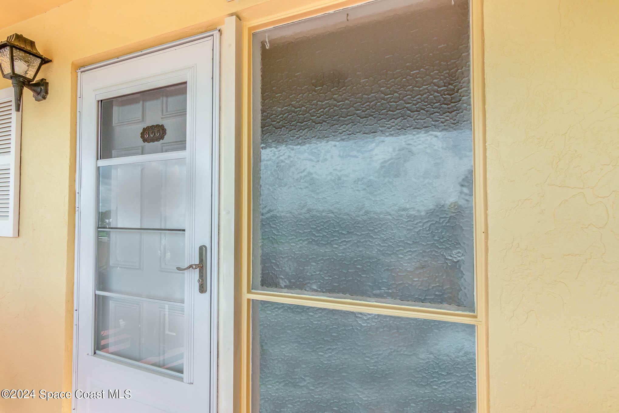 300 South Banana River Boulevard, Unit 305 Cocoa Beach, FL 32931 - Photo 5 of 36 a bathroom with a glass shower door