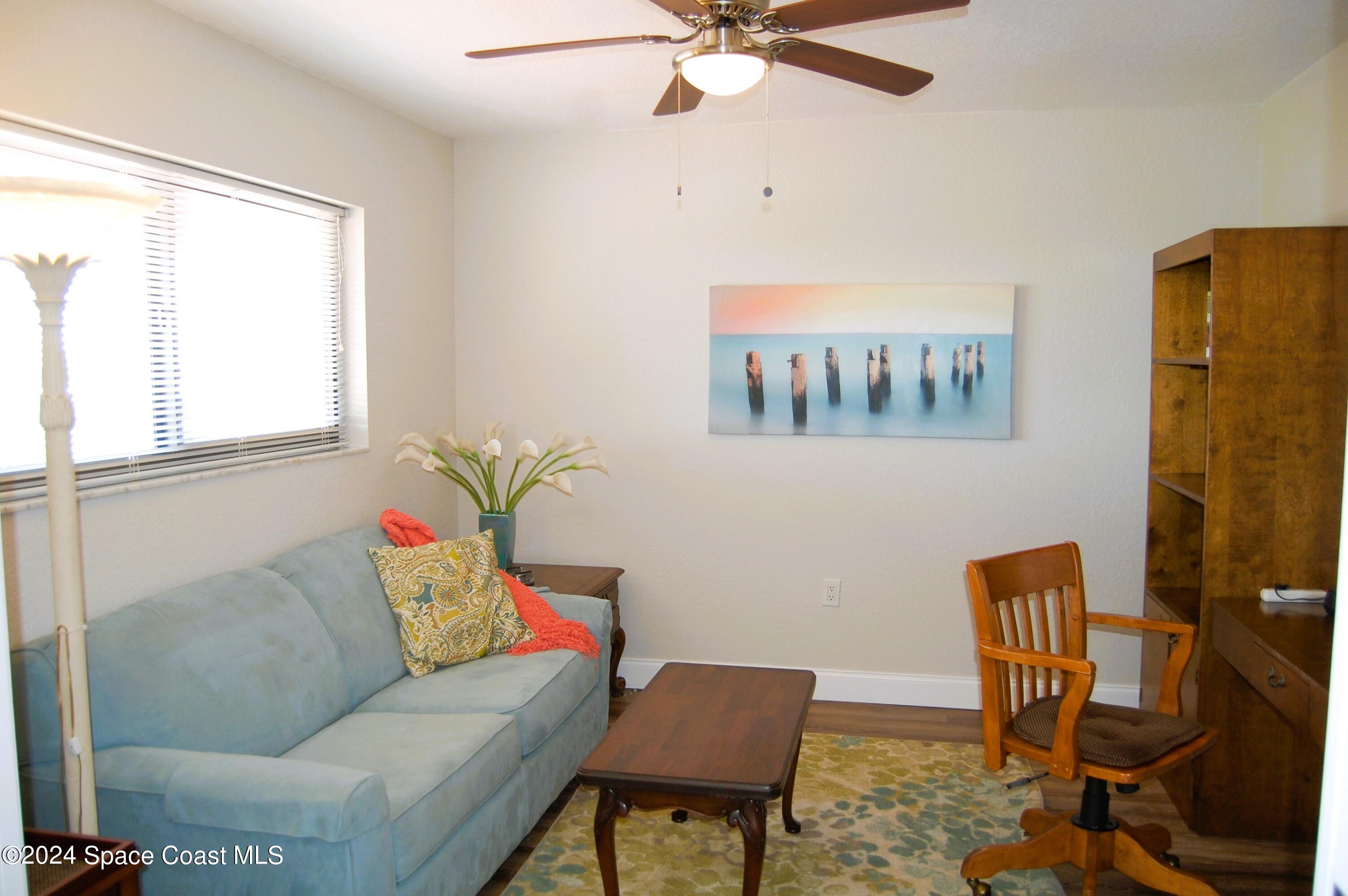 300 South Banana River Boulevard, Unit 305 Cocoa Beach, FL 32931 - Photo 9 of 36 a living room with furniture and a window