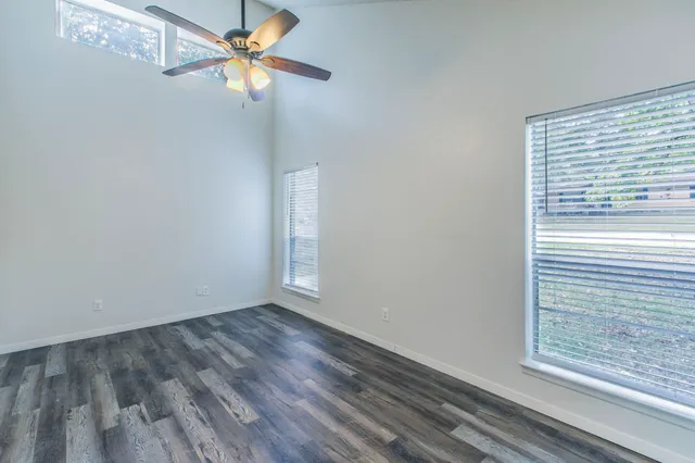 a view of a room with a window and wooden floor