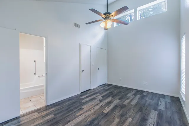 a view of an empty room with wooden floor