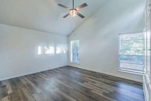 wooden floor in an empty room with a window