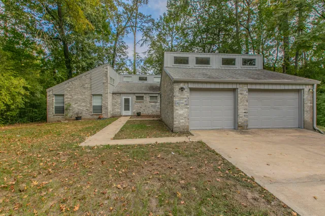 a view of a house with a yard and garage