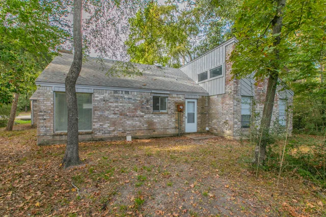 a view of a house with a tree