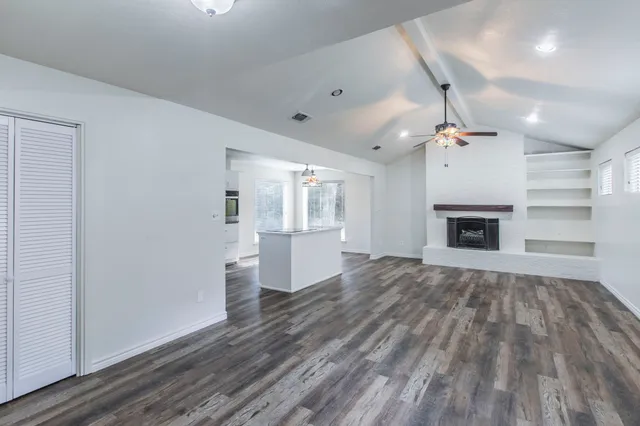 wooden floor in an empty room with a fireplace