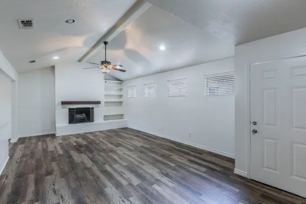 wooden floor in an empty room with a fireplace