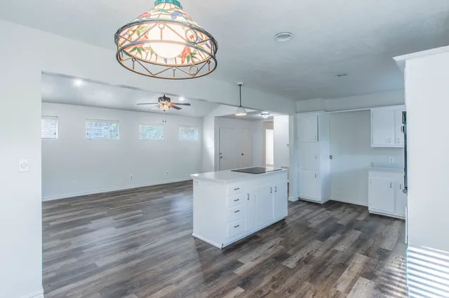 a view of a kitchen with wooden floor and window