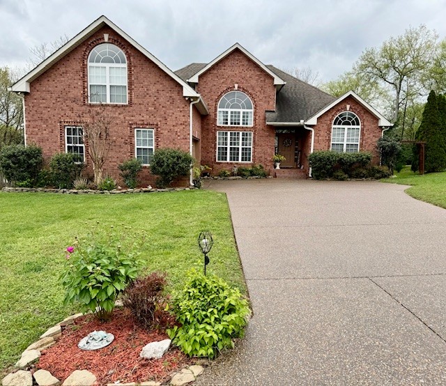 a front view of a house with a yard and garage