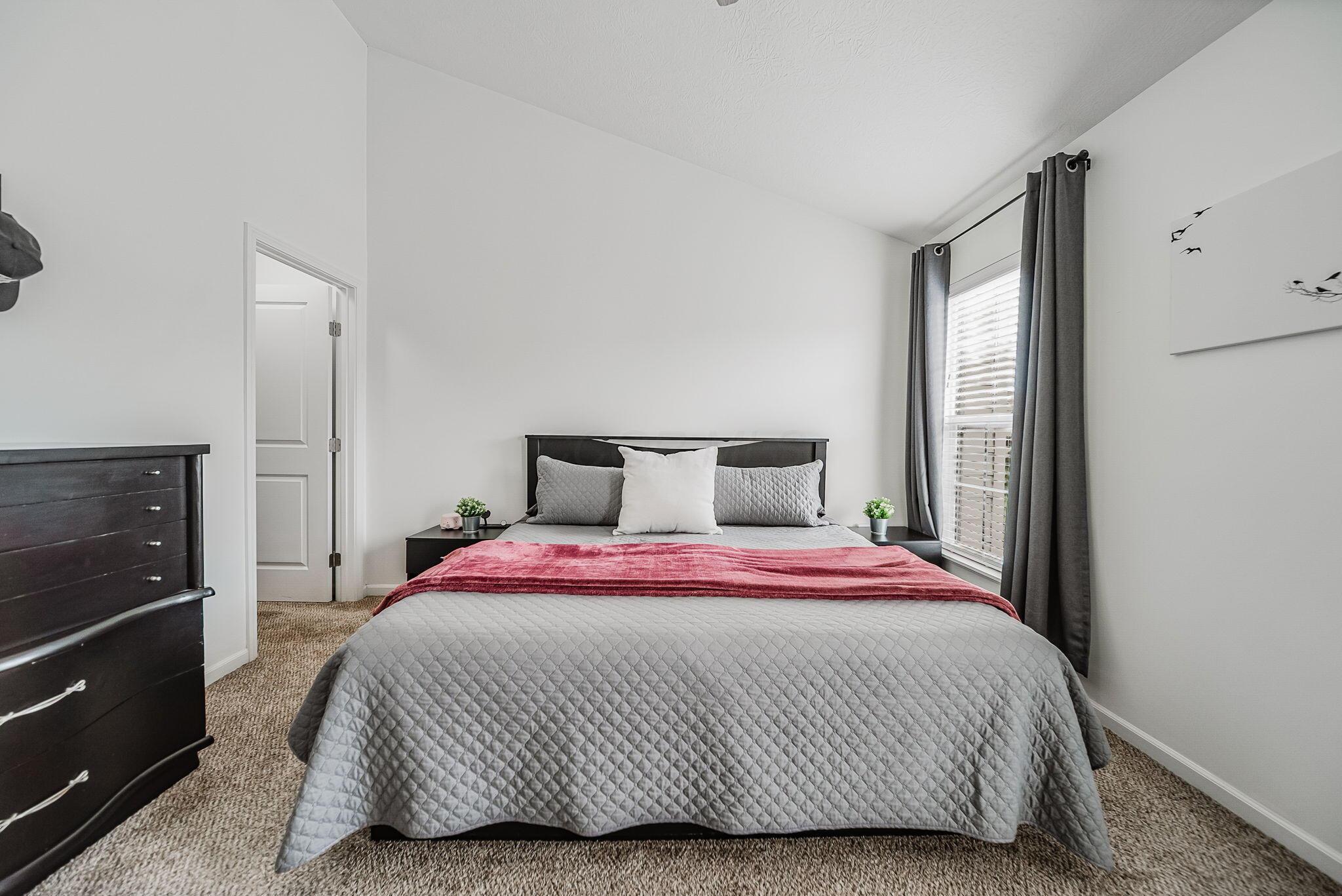 6186 Needletail Road, Unit 66 Columbus, OH 43230 - Photo 15 of 48 Bedroom #1 has vaulted ceilings, overhead lighting/fan, neutral decor, large walk-in closet, and generous en-suite bathroom!