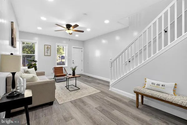 a living room with furniture and a chandelier