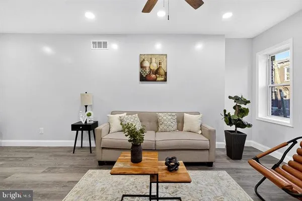 a living room with furniture and a potted plant