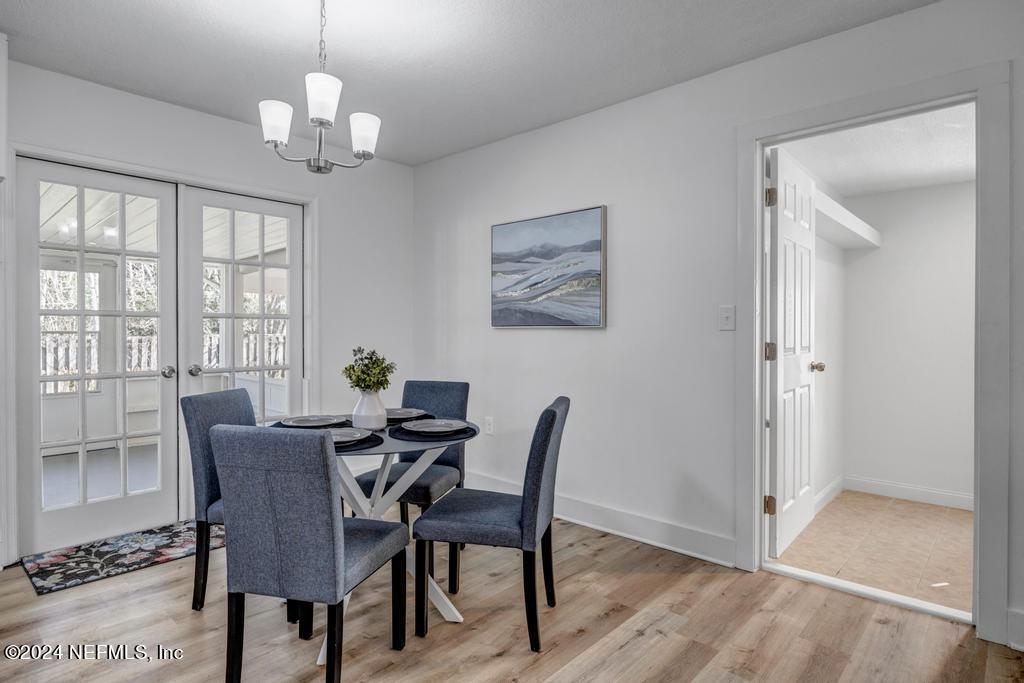 903 Royal Road St. Augustine, FL 32086 - Photo 11 of 32 a view of a dining room with furniture wooden floor and chandelier