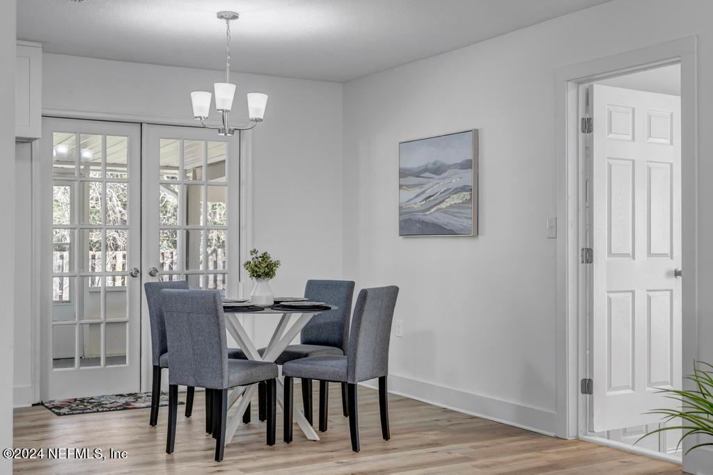 903 Royal Road St. Augustine, FL 32086 - Photo 12 of 32 a view of a dining room with furniture wooden floor and chandelier