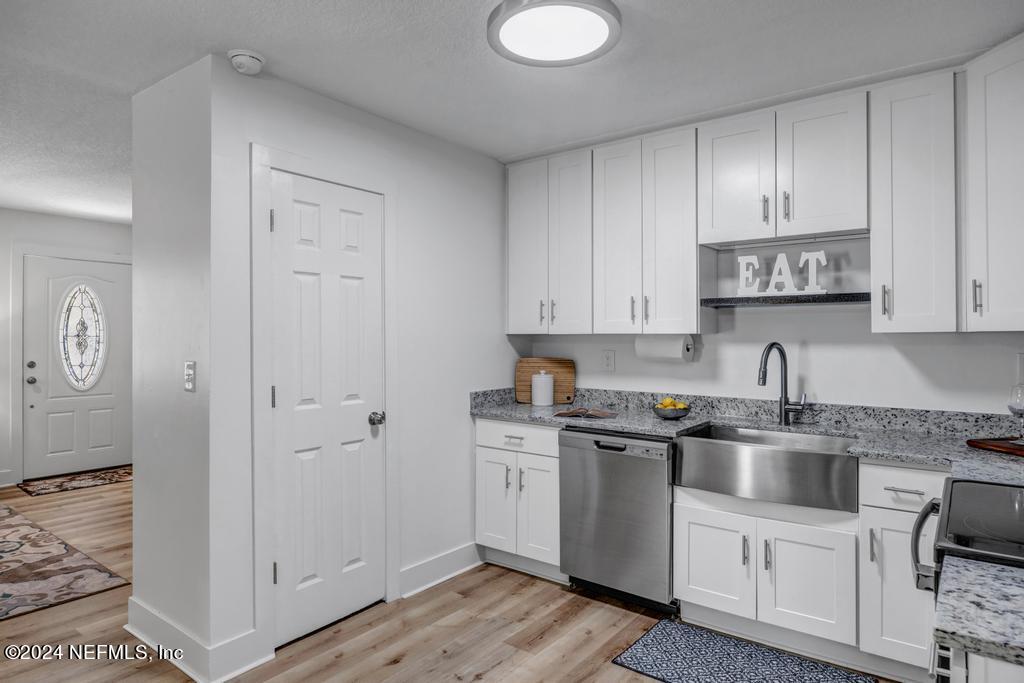 903 Royal Road St. Augustine, FL 32086 - Photo 16 of 32 a kitchen with white cabinets and sink