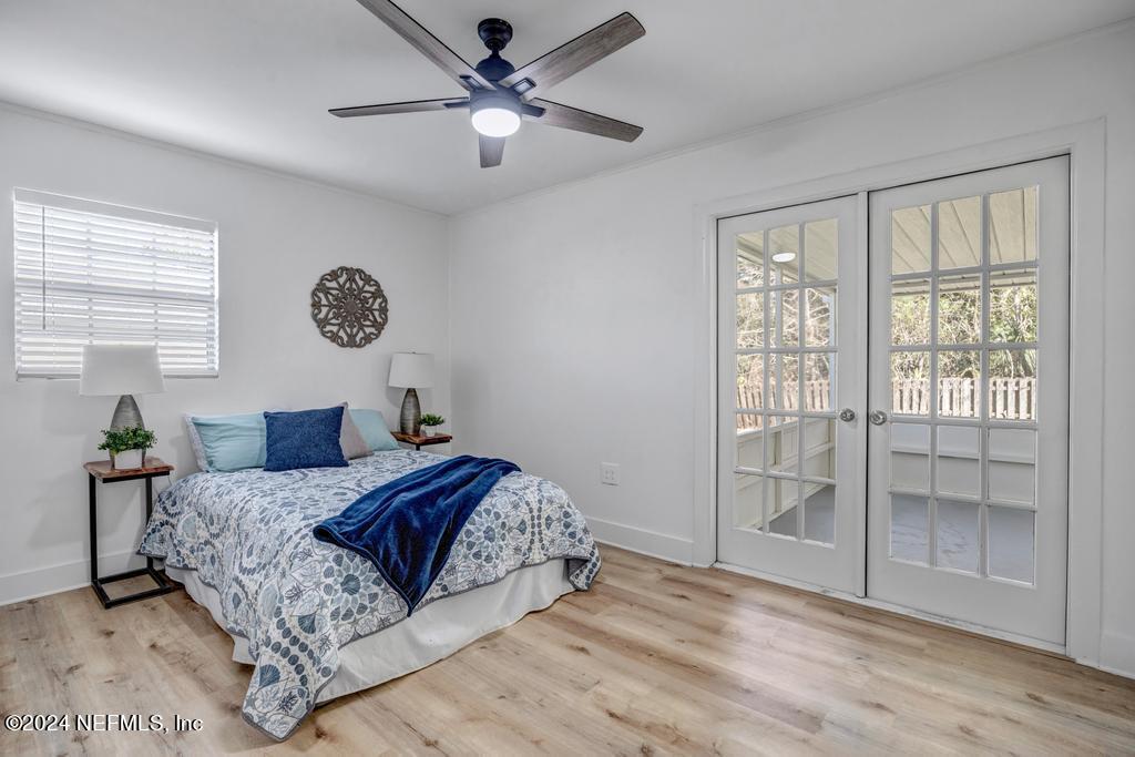 903 Royal Road St. Augustine, FL 32086 - Photo 23 of 32 a bedroom with a large bed and a chandelier