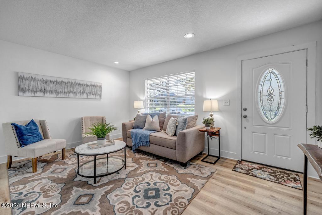 903 Royal Road St. Augustine, FL 32086 - Photo 5 of 32 a living room with furniture a clock and a window
