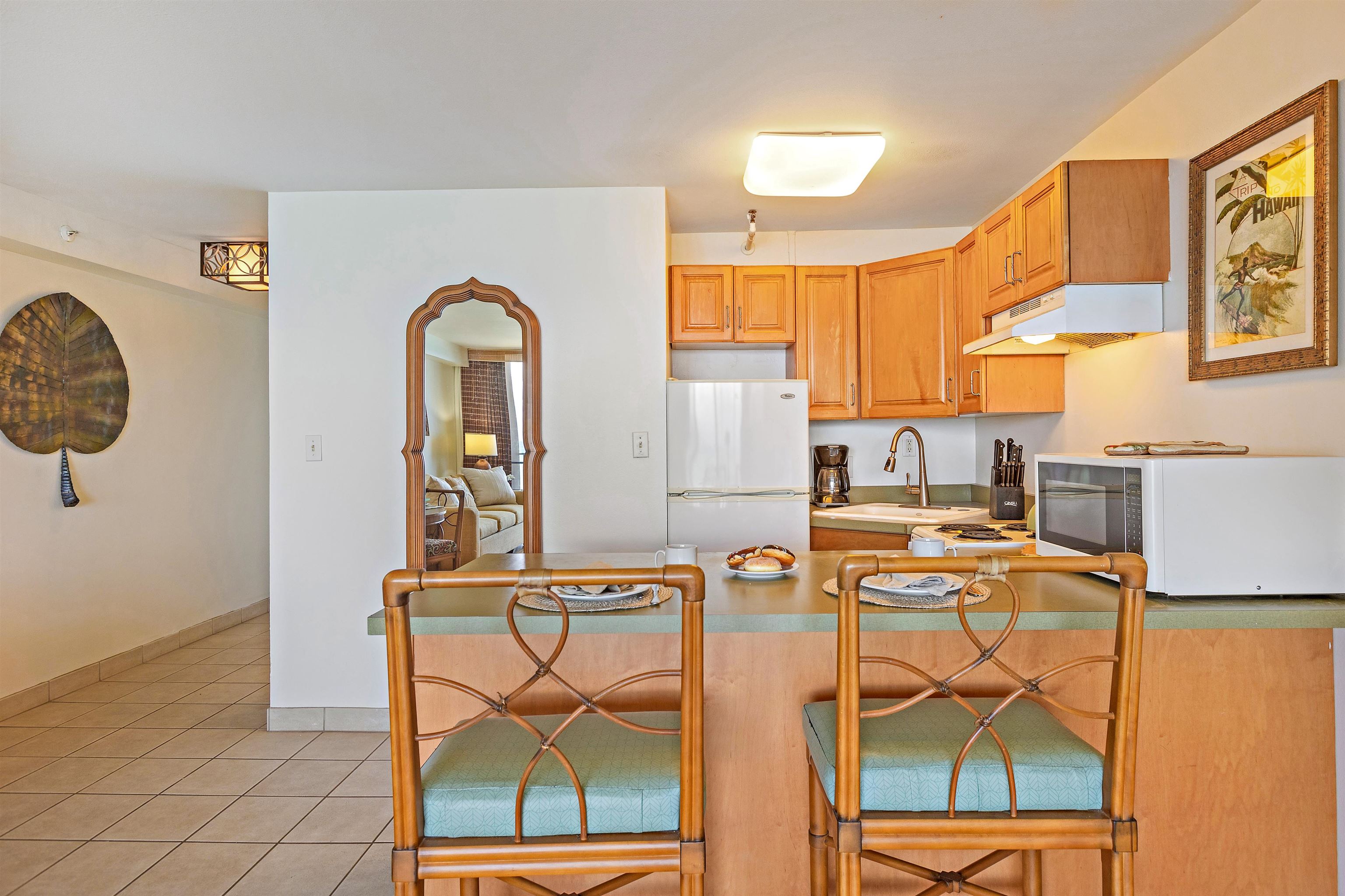 4327 Lower Honoapiilani Road, Unit 406B Lahaina, HI 96761 - Photo 11 of 26 a view of a kitchen with stainless steel appliances wooden floor and a window