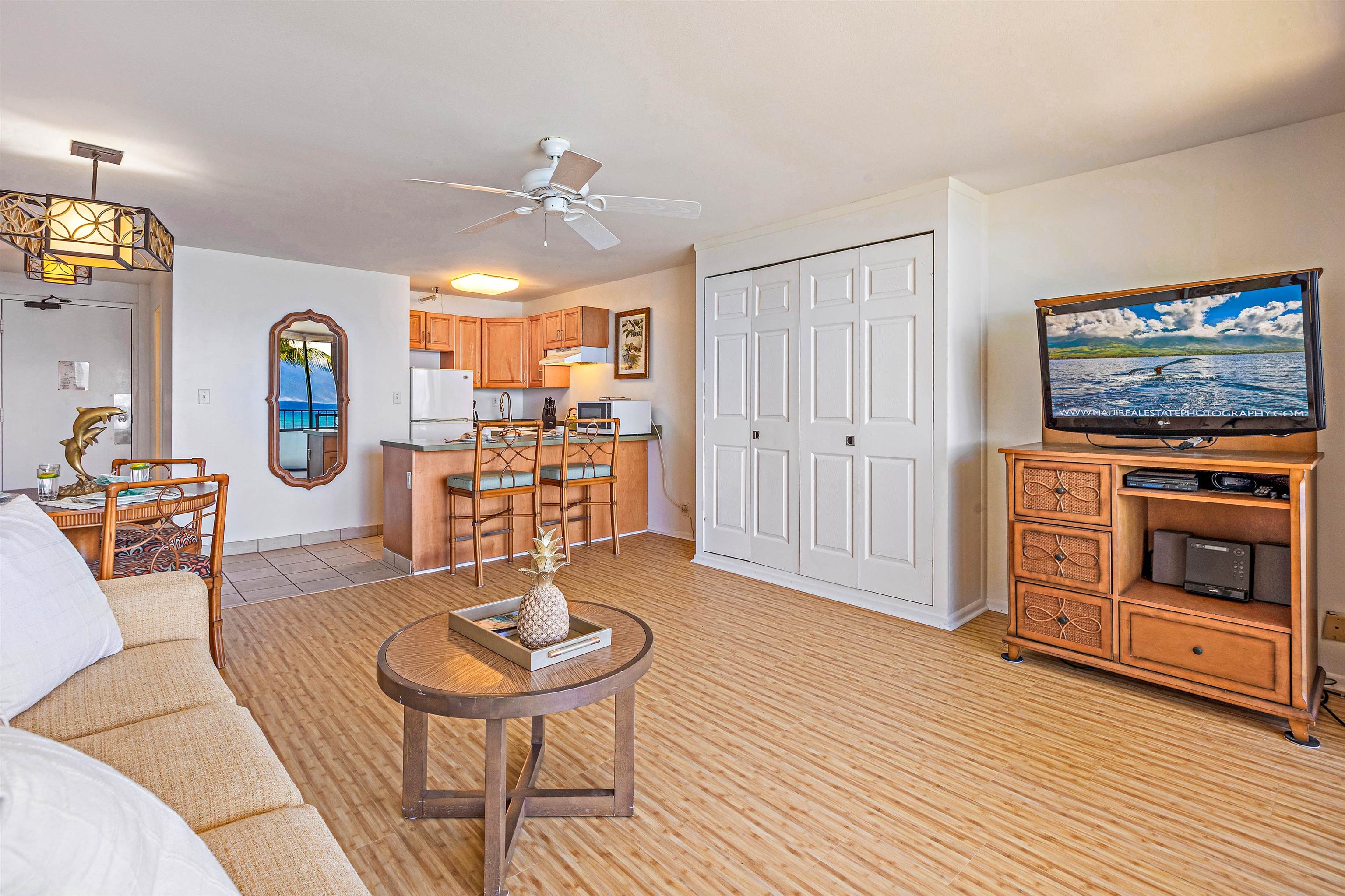 4327 Lower Honoapiilani Road, Unit 406B Lahaina, HI 96761 - Photo 12 of 26 a living room with furniture and a wooden floor