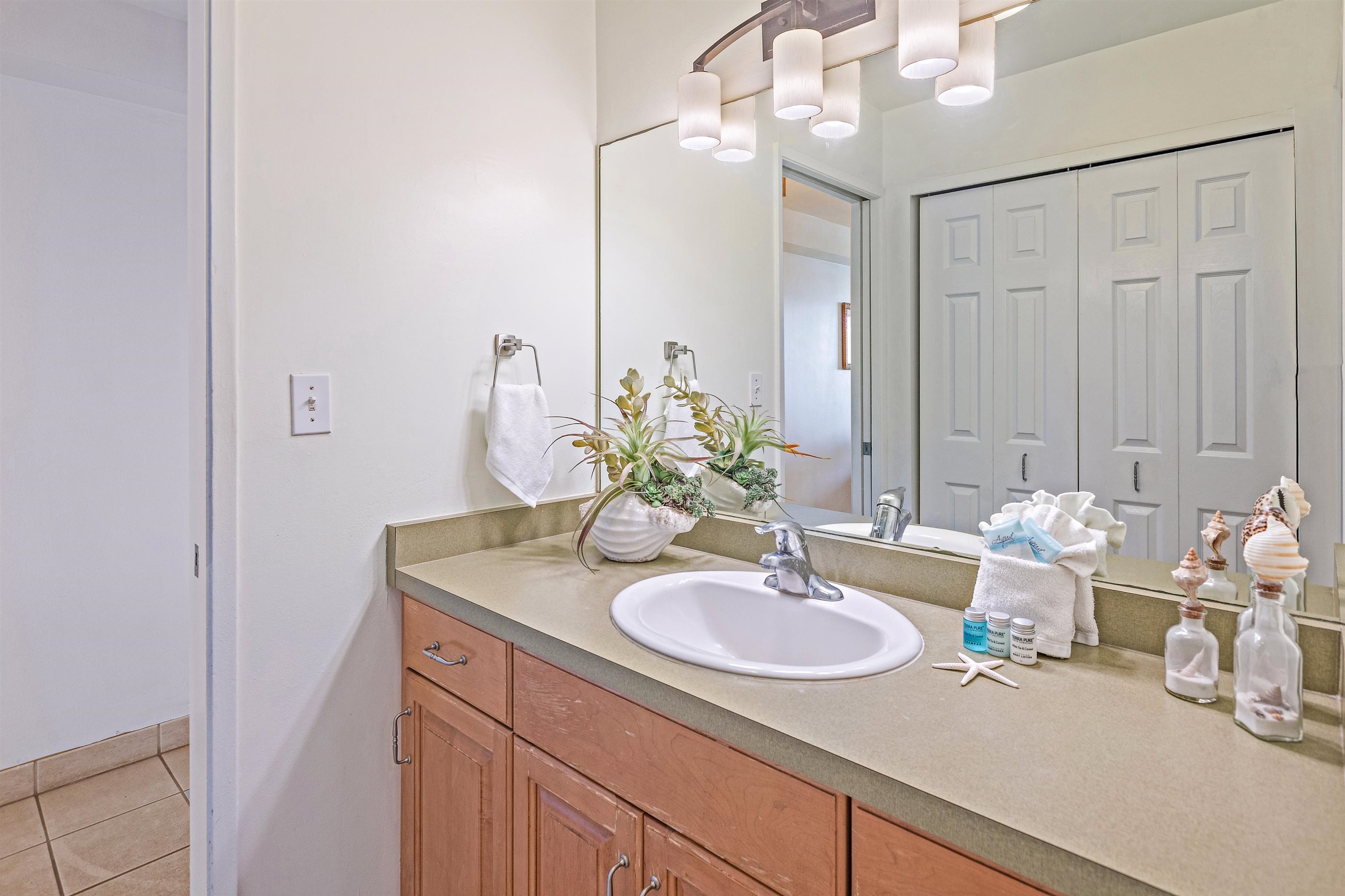 4327 Lower Honoapiilani Road, Unit 406B Lahaina, HI 96761 - Photo 18 of 26 a bathroom with a sink double vanity and a mirror