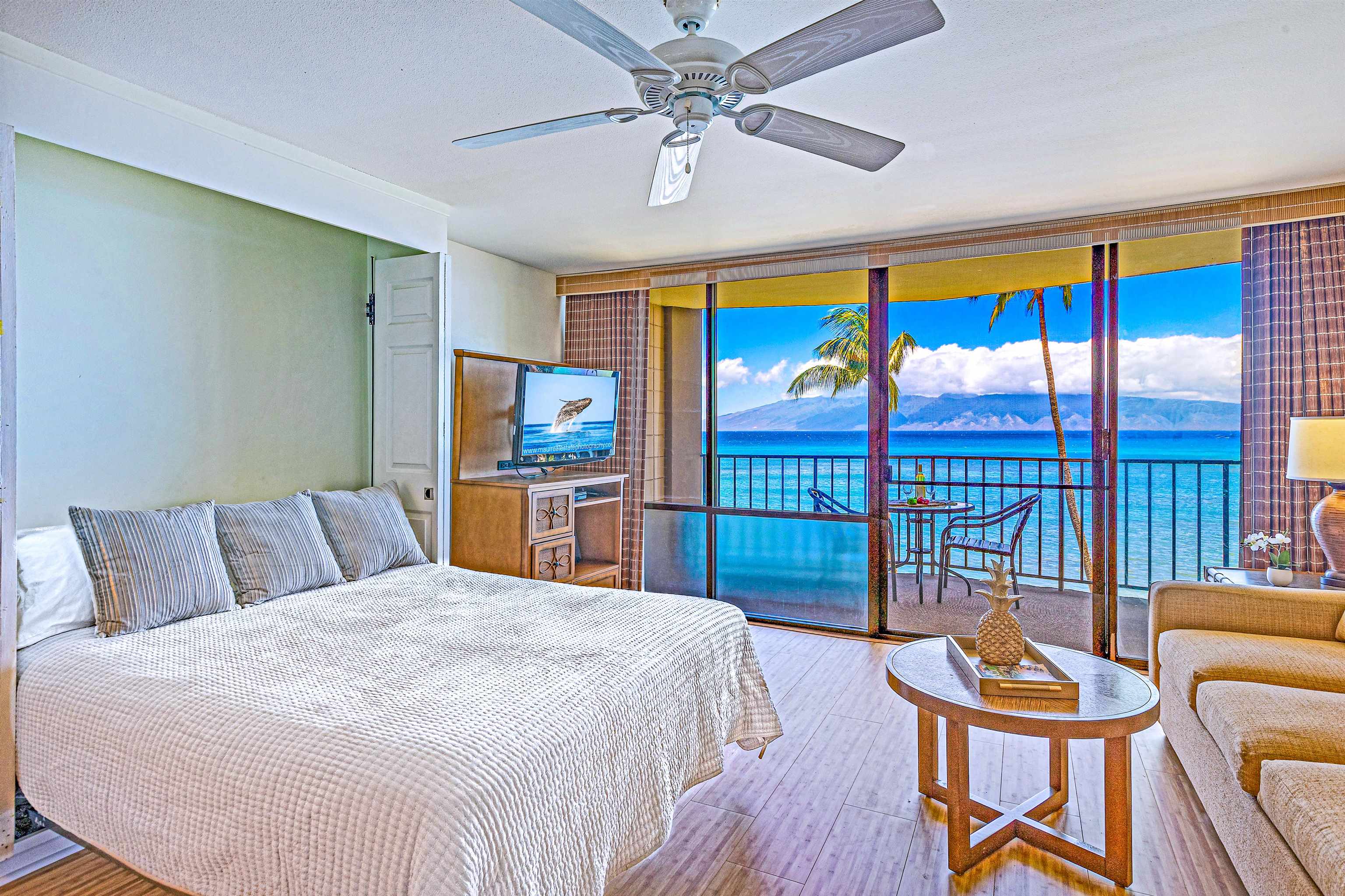 4327 Lower Honoapiilani Road, Unit 406B Lahaina, HI 96761 - Photo 5 of 26 a bed room with furniture and a floor to ceiling window