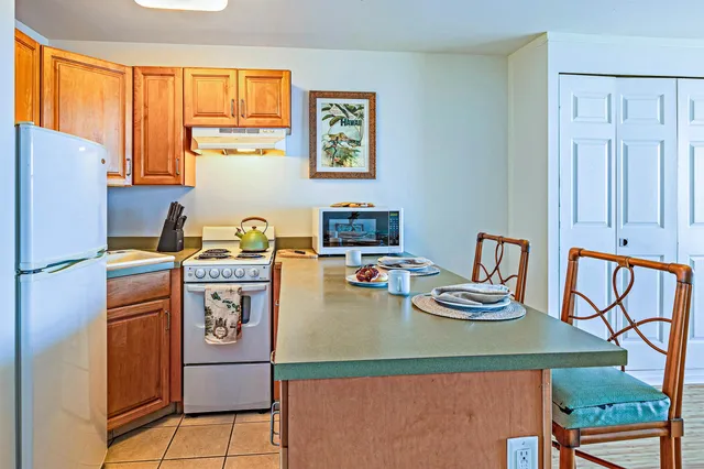 a dining room with furniture a window and a kitchen