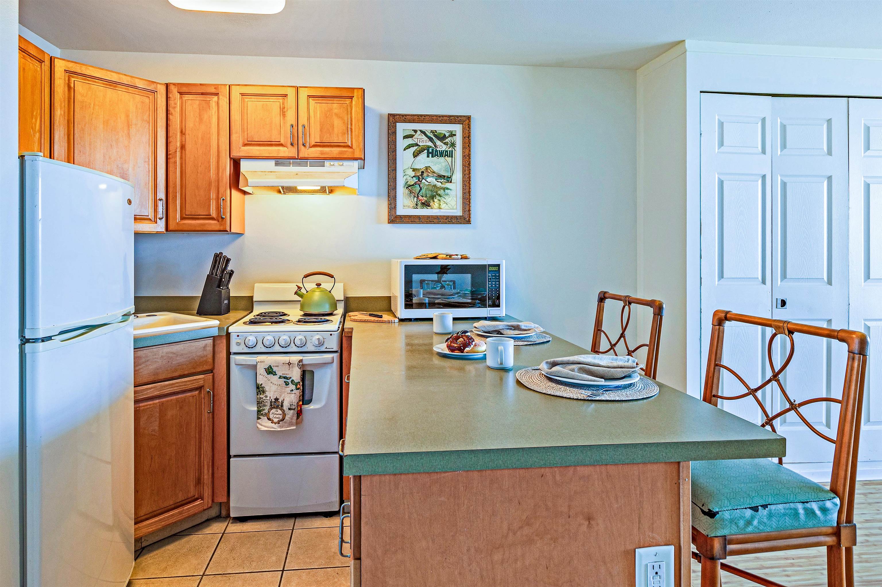 4327 Lower Honoapiilani Road, Unit 406B Lahaina, HI 96761 - Photo 7 of 26 a dining room with furniture a window and a kitchen