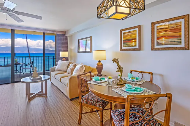 a living room with furniture a flat screen tv and a floor to ceiling window