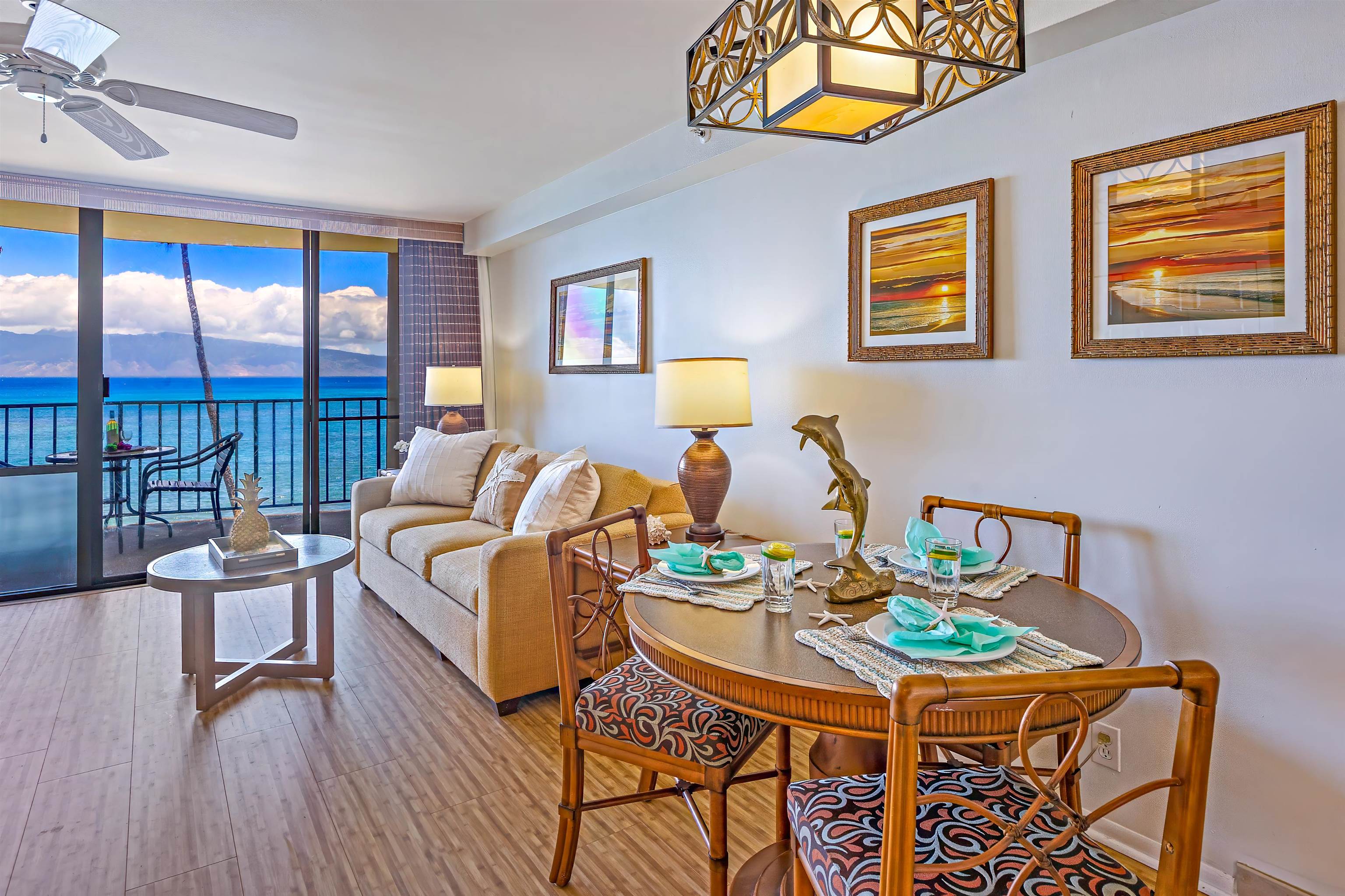 4327 Lower Honoapiilani Road, Unit 406B Lahaina, HI 96761 - Photo 10 of 26 a living room with furniture a flat screen tv and a floor to ceiling window