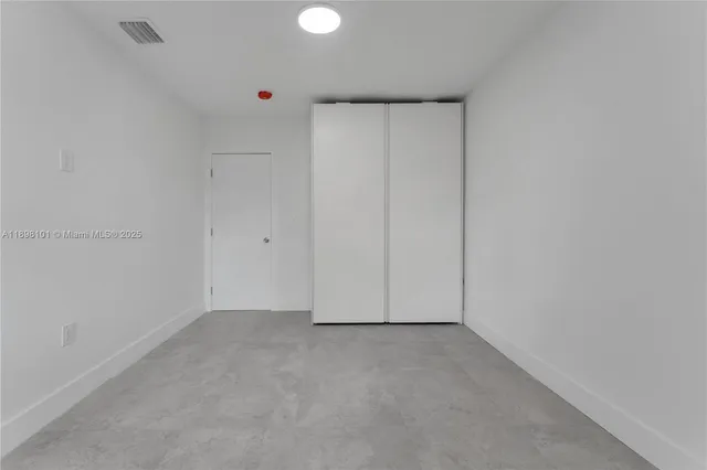 a bathroom with a toilet a sink a window and mirror