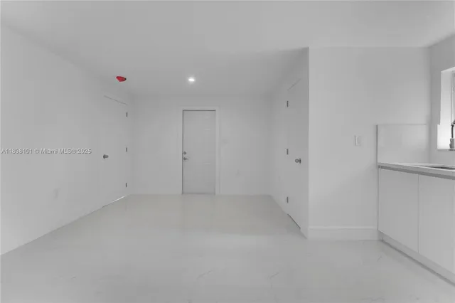 a white toilet sitting next to a bathroom sink