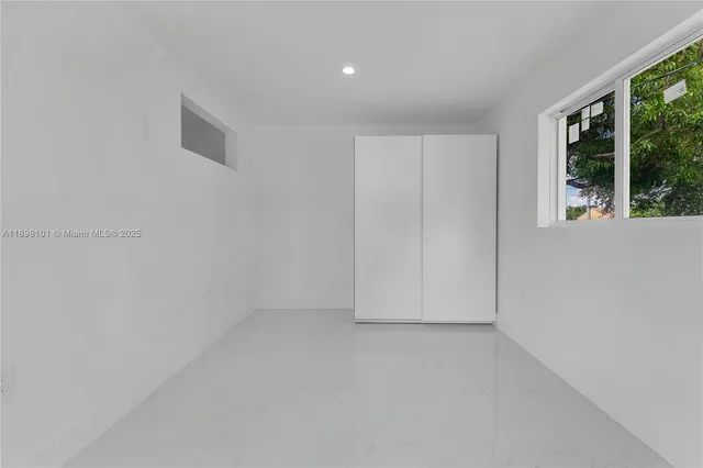 a view of a house with backyard and a tree