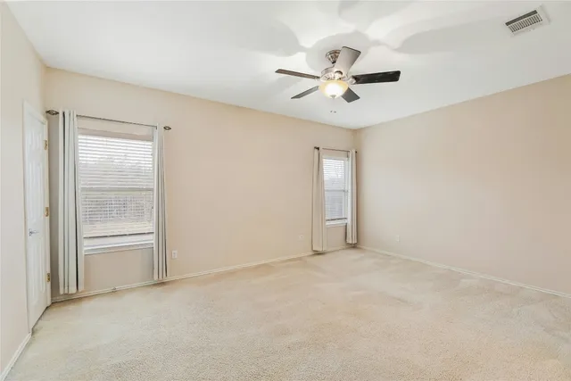 a spacious bathroom with a bathtub shower sink mirror and toilet