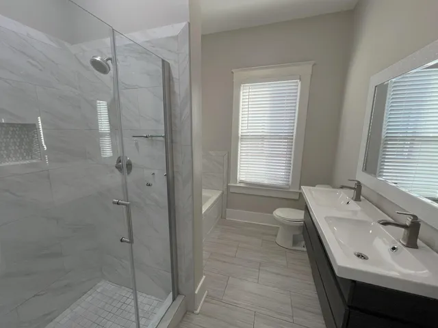 a bathroom with a tub sink and mirror