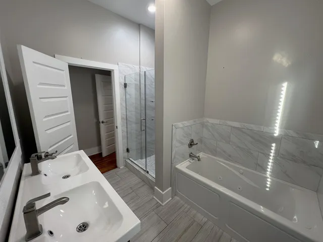 a bathroom with a tub sink and mirror