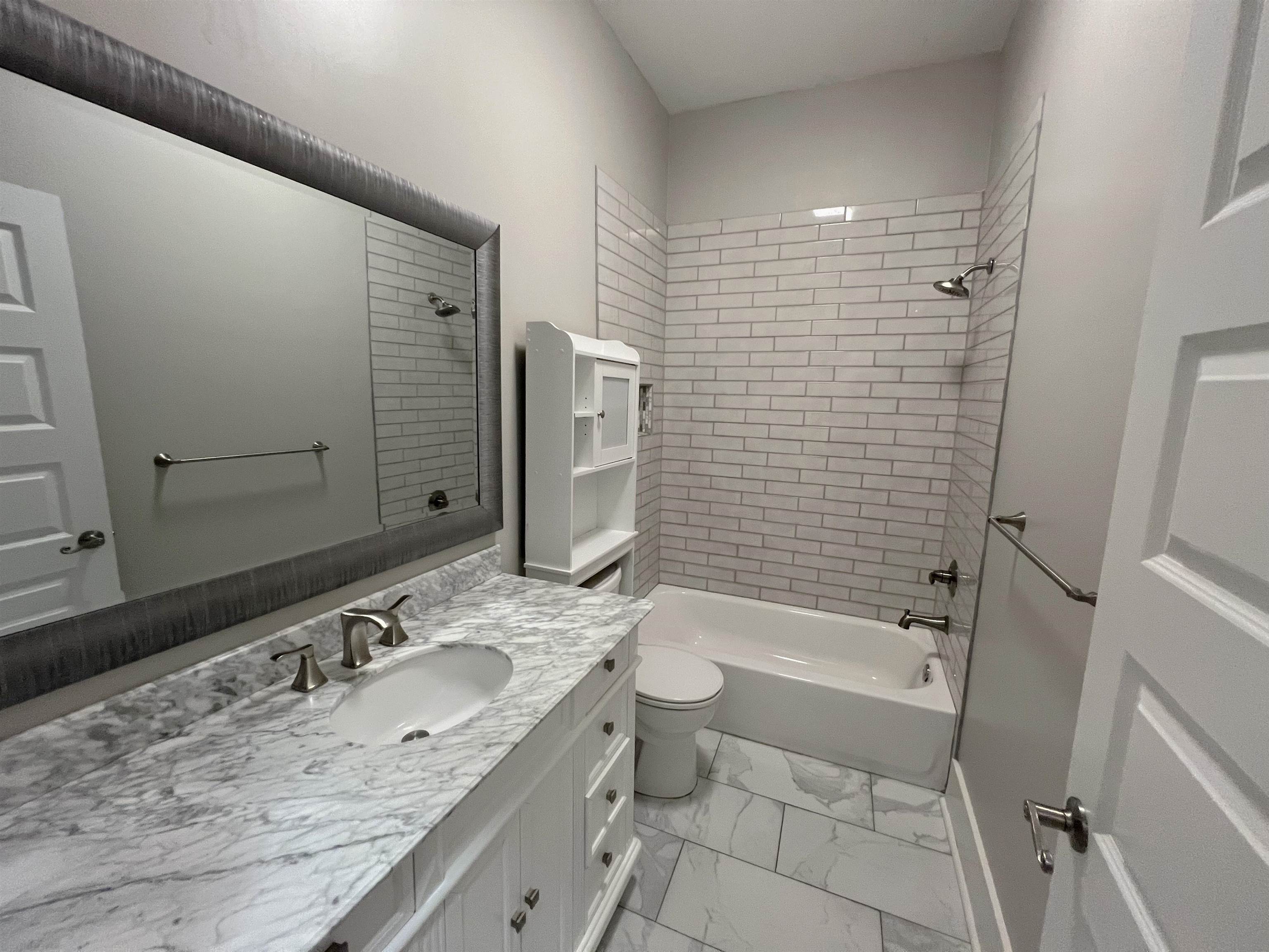 897 South Cox Street Memphis, TN 38104 - Photo 10 of 14 a bathroom with a granite countertop sink toilet and shower