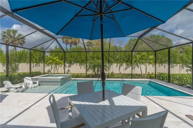 a view of a patio with a table chairs under an umbrella