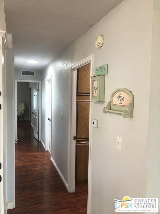 69525 Dillon Road, Unit 73 Desert Hot Springs, CA 92241 - Photo 14 of 48 a view of a hallway with wooden floor