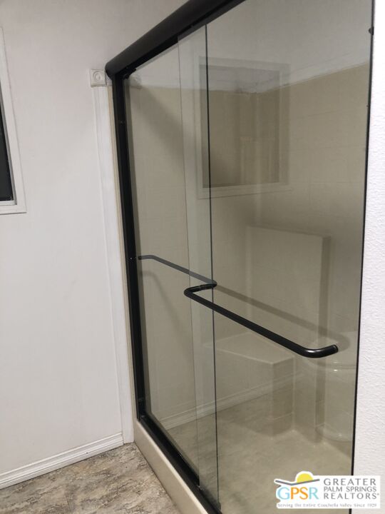 69525 Dillon Road, Unit 73 Desert Hot Springs, CA 92241 - Photo 17 of 48 a bathroom with a glass shower door