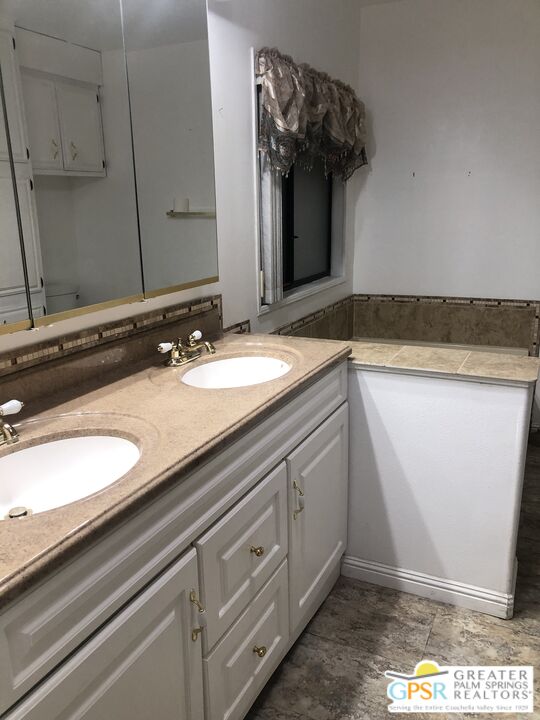 69525 Dillon Road, Unit 73 Desert Hot Springs, CA 92241 - Photo 20 of 48 a bathroom with a sink and a mirror