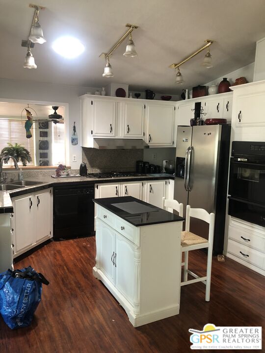 69525 Dillon Road, Unit 73 Desert Hot Springs, CA 92241 - Photo 2 of 48 a kitchen with a stove a sink and a refrigerator