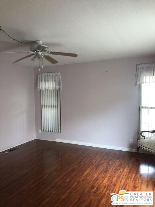 69525 Dillon Road, Unit 73 Desert Hot Springs, CA 92241 - Photo 21 of 48 wooden floor in an empty room with a window