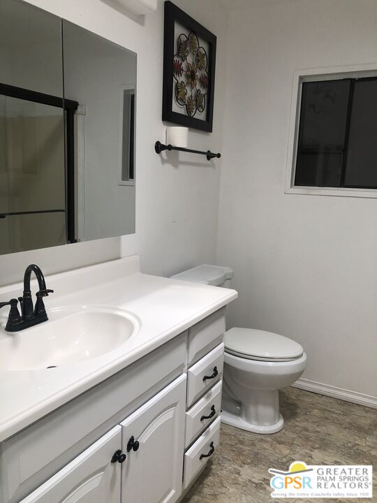 69525 Dillon Road, Unit 73 Desert Hot Springs, CA 92241 - Photo 22 of 48 a bathroom with a sink toilet and mirror