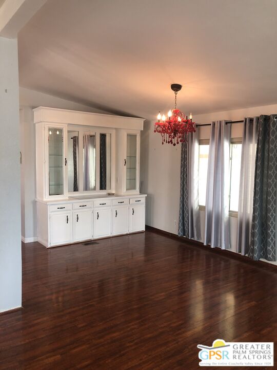 69525 Dillon Road, Unit 73 Desert Hot Springs, CA 92241 - Photo 3 of 48 a view of an empty room with wooden floor and a window