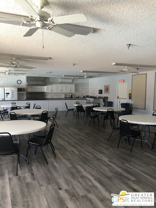 69525 Dillon Road, Unit 73 Desert Hot Springs, CA 92241 - Photo 31 of 48 a view of a dining room with furniture wooden floor and chandelier