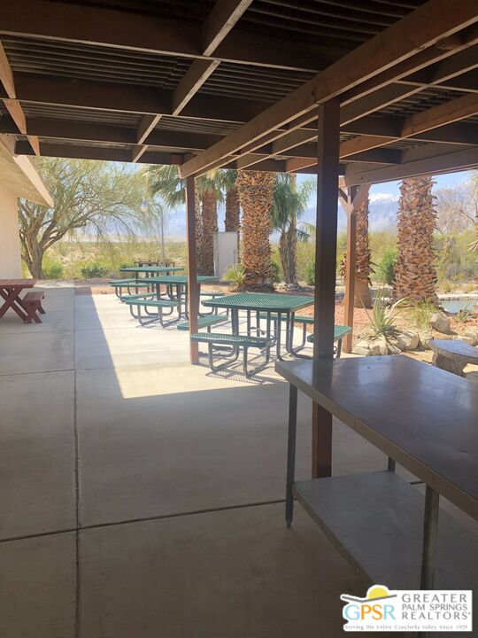 69525 Dillon Road, Unit 73 Desert Hot Springs, CA 92241 - Photo 32 of 48 a view of a living room with a floor to ceiling window and outside view