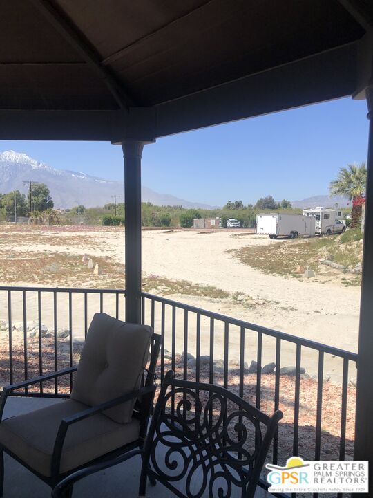 69525 Dillon Road, Unit 73 Desert Hot Springs, CA 92241 - Photo 34 of 48 a view of a balcony with wooden chairs