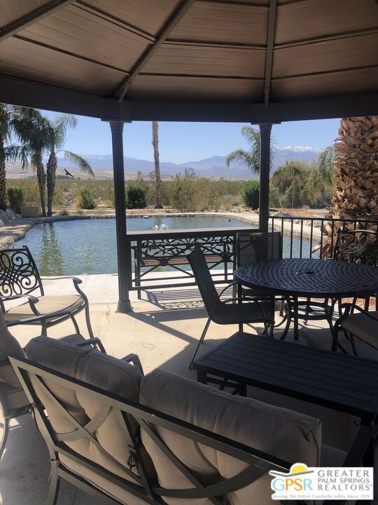 69525 Dillon Road, Unit 73 Desert Hot Springs, CA 92241 - Photo 35 of 48 a view of a balcony with furniture and wooden floor